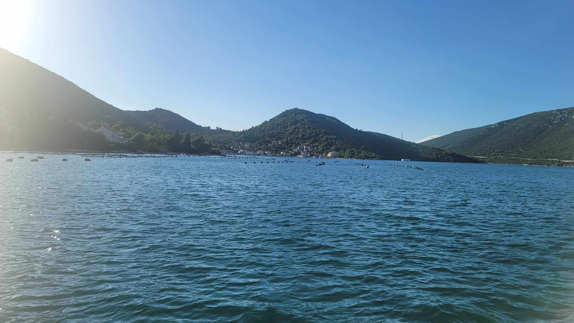 blue ocean with mountains in the distance