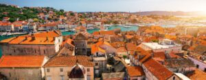 Overview of the terracotta rooftops and Adriatic Sea as seen from a Trogir vacation.