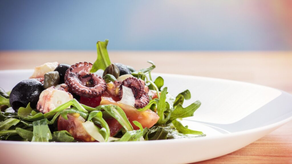 Croatian octopus salad on a white plate. 